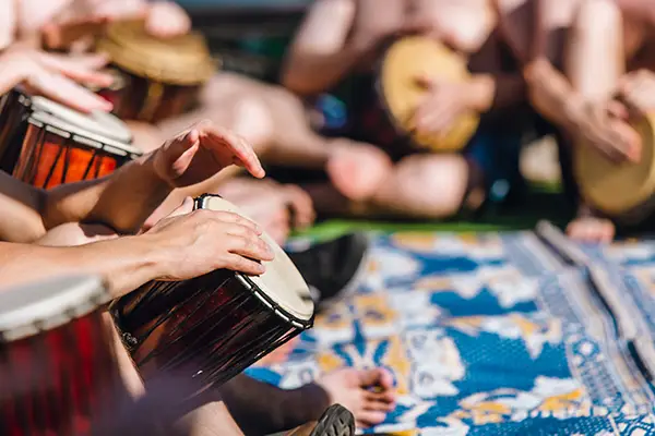 People having fun playing with their hands in a drum circle on d
